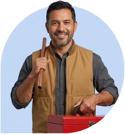 A plumber holding a length of copper pipe, his hand on a red toolbox.