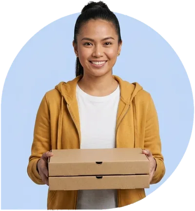 A delivery driver holding two pizza boxes, ready to hand them over.